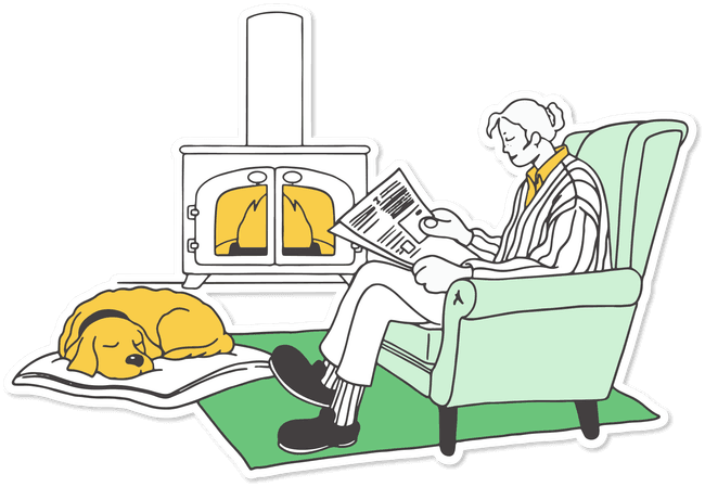 A woman reading the newspaper by the fire with a dozing dog.